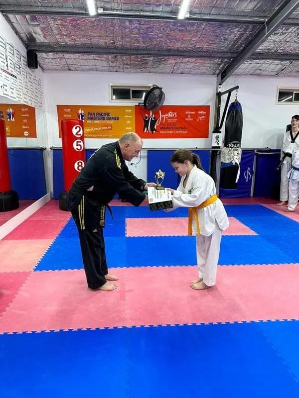 A Older Man Black Uniform And A Girl White Uniform With Certificate Taekwondo — Tae Kwon Do Lessons in Port Stephens