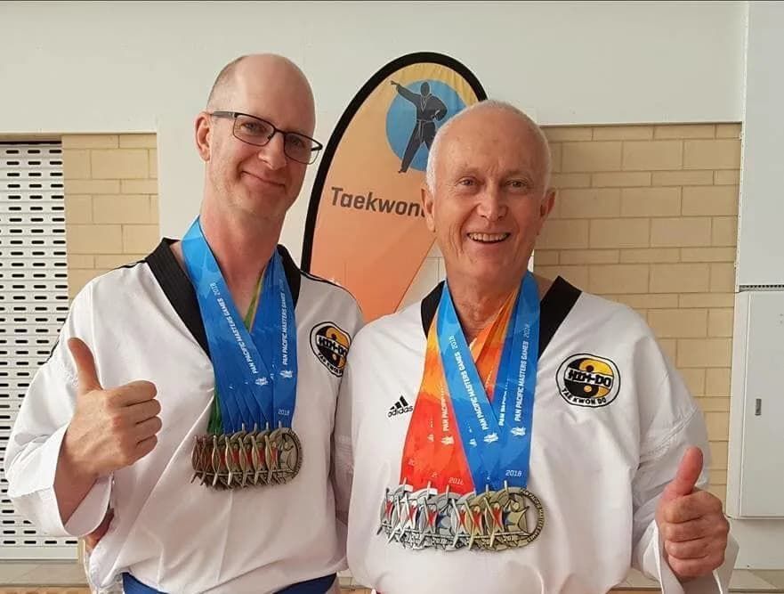 Two Older Men Taekwondo With Medals — Tae Kwon Do Lessons in Port Stephens
