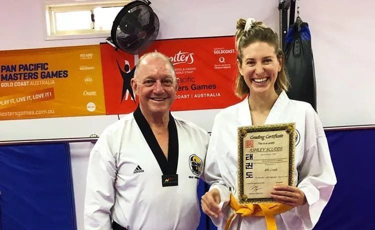 A Man Older Black Uniform And Woman White Uniform With Certificate — Tae Kwon Do Lessons in Port Stephens