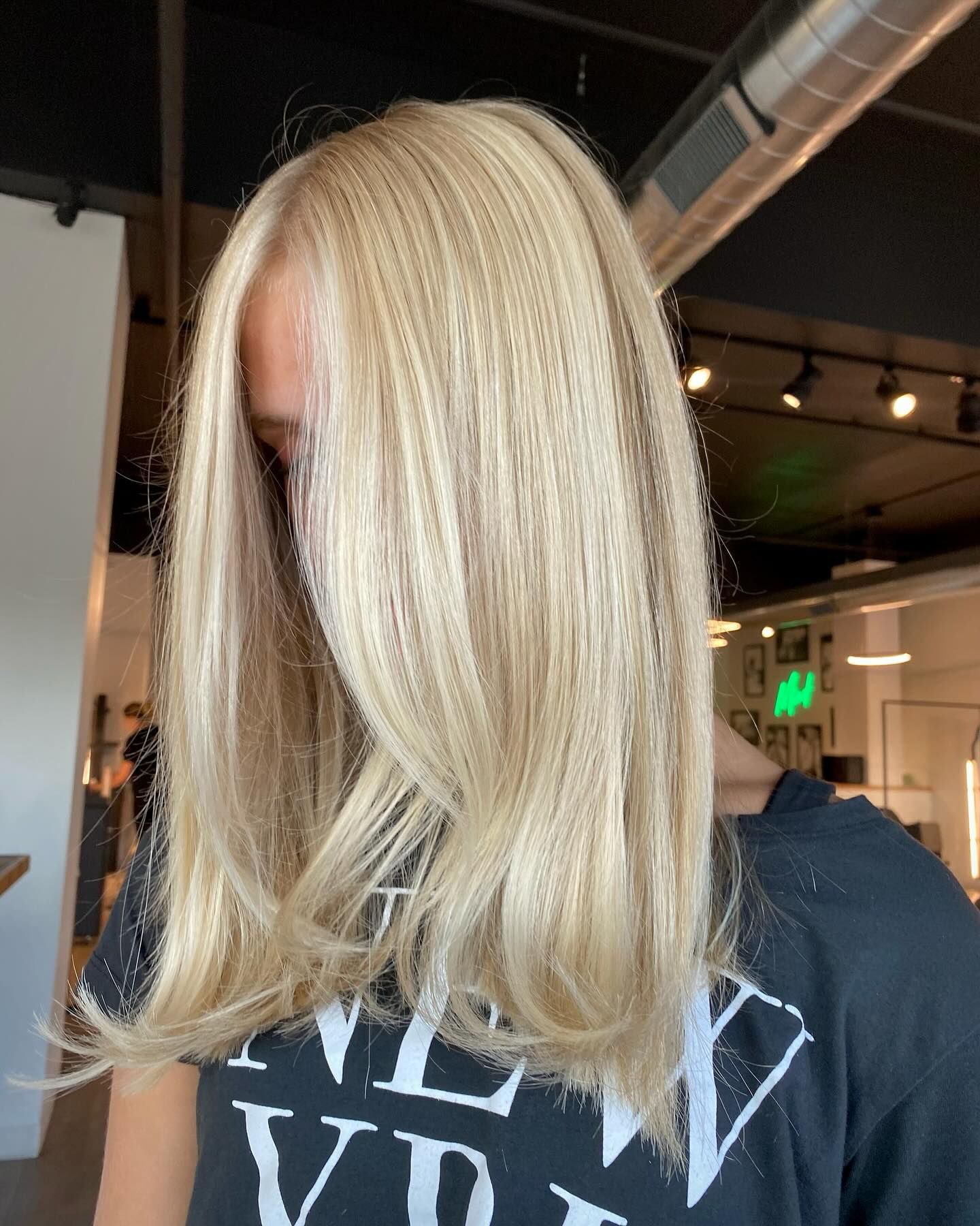 A woman with blonde hair is wearing a new york t-shirt.