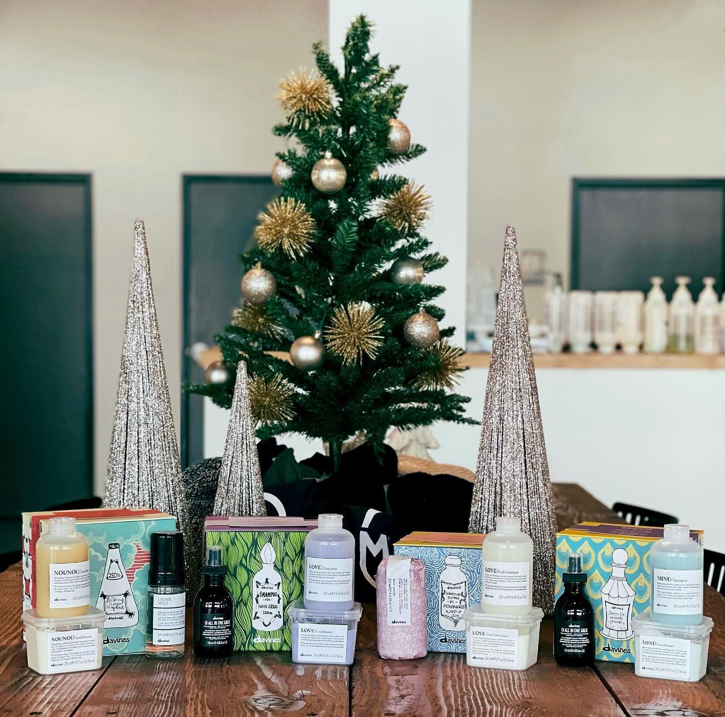 A christmas tree is surrounded by bottles of hair products