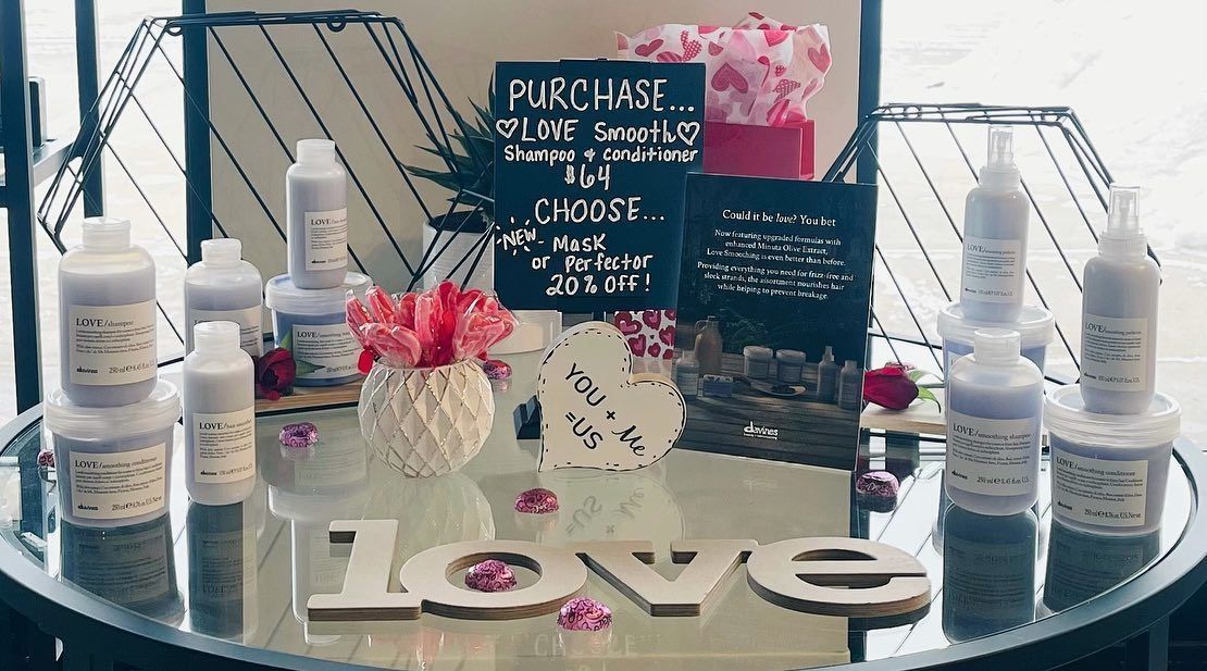 A table with bottles and a sign that says `` love '' on it.