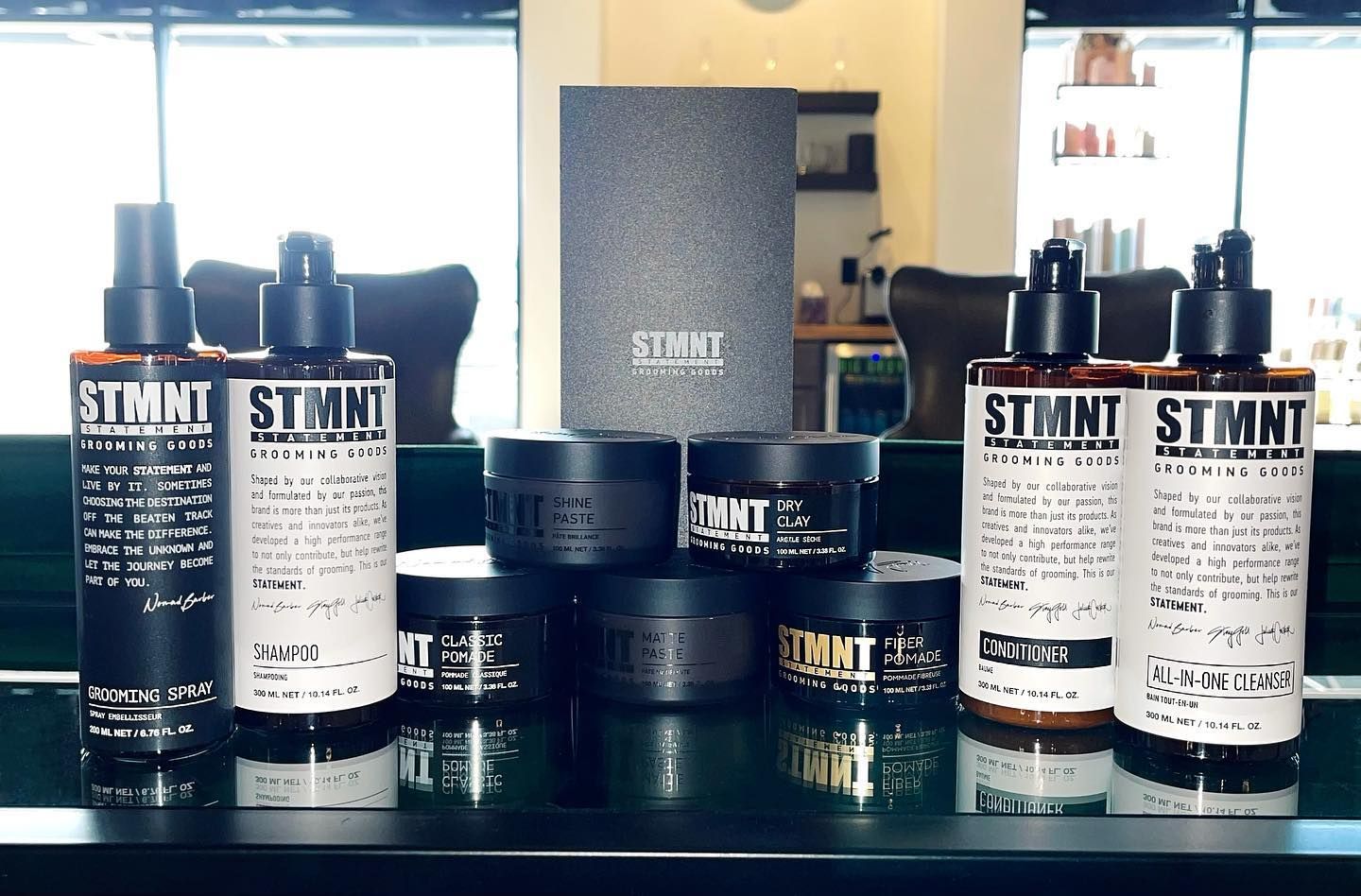 Several bottles of stani products are lined up on a table