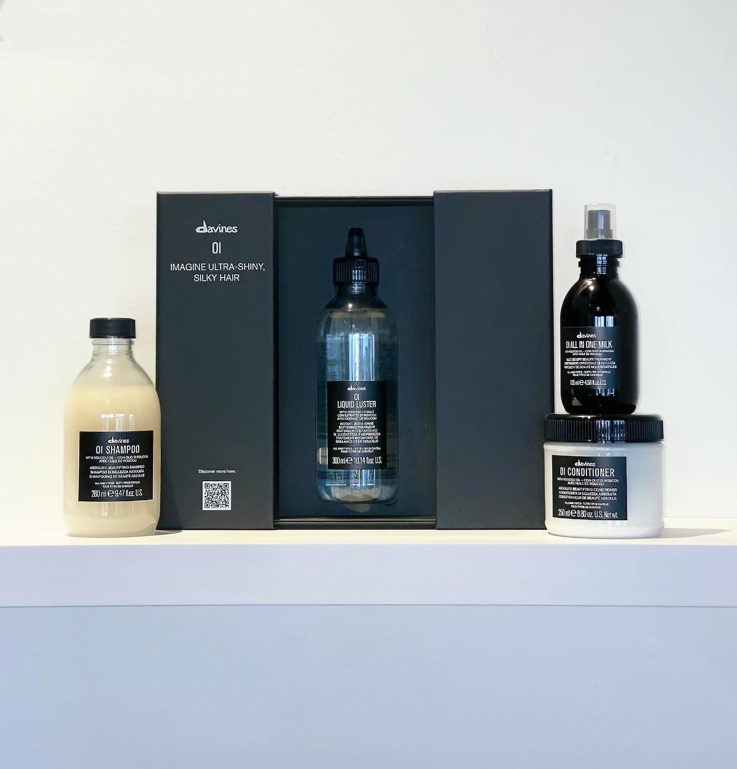 Three bottles of hair products are sitting on a shelf