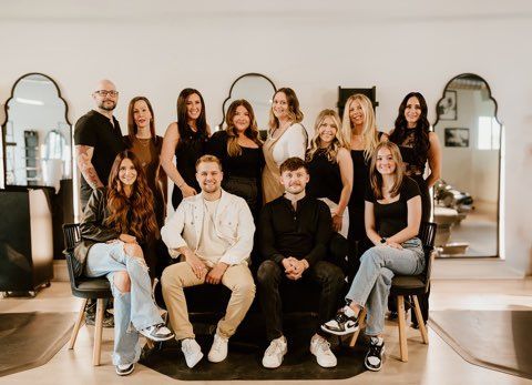 A white truck is parked in a parking lot next to a building.