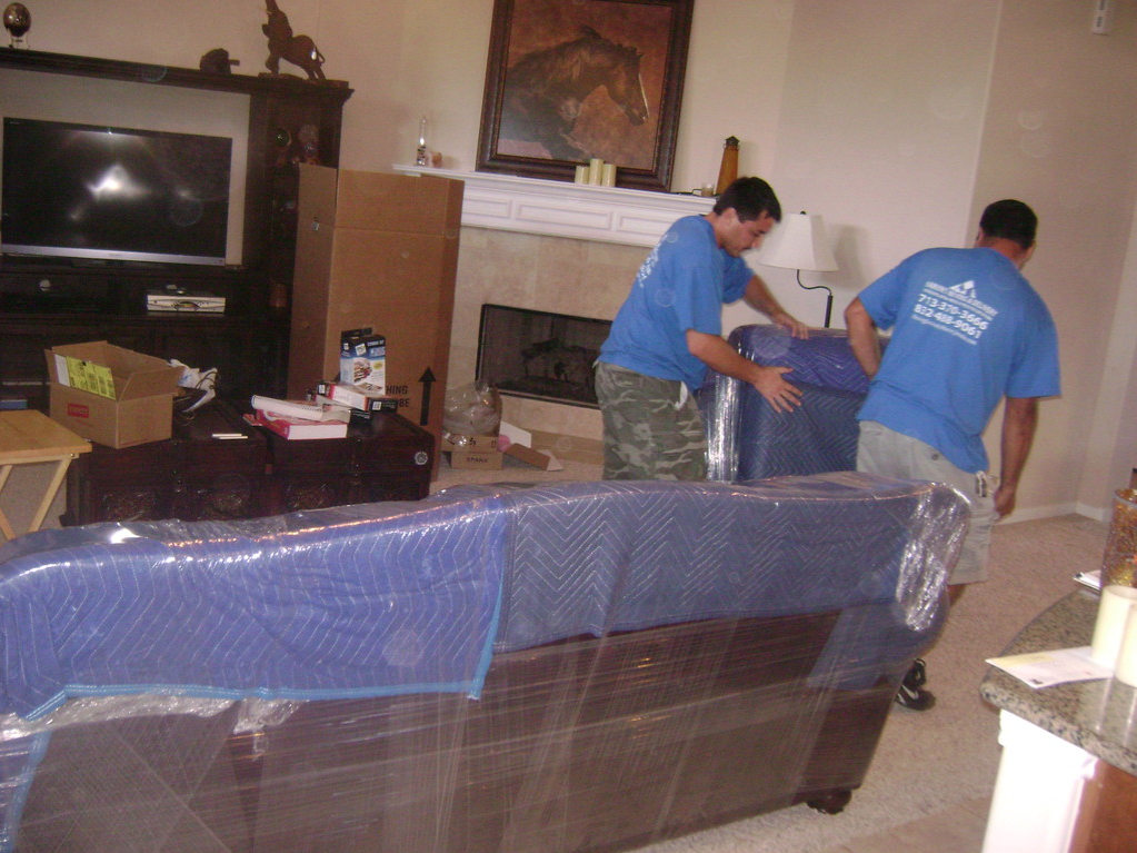 two man carrying sofa