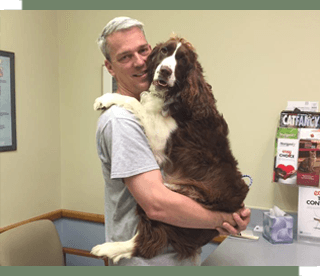 Vet Holding Dog at Animal Hospital in Boiling Springs, SC