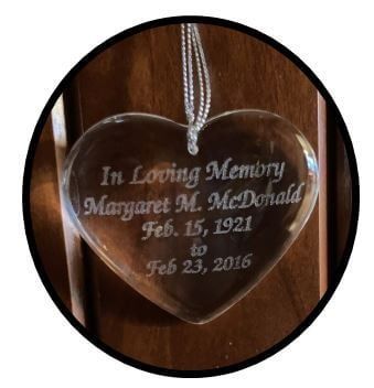 Clear heart-shaped memorial ornament with inscription: