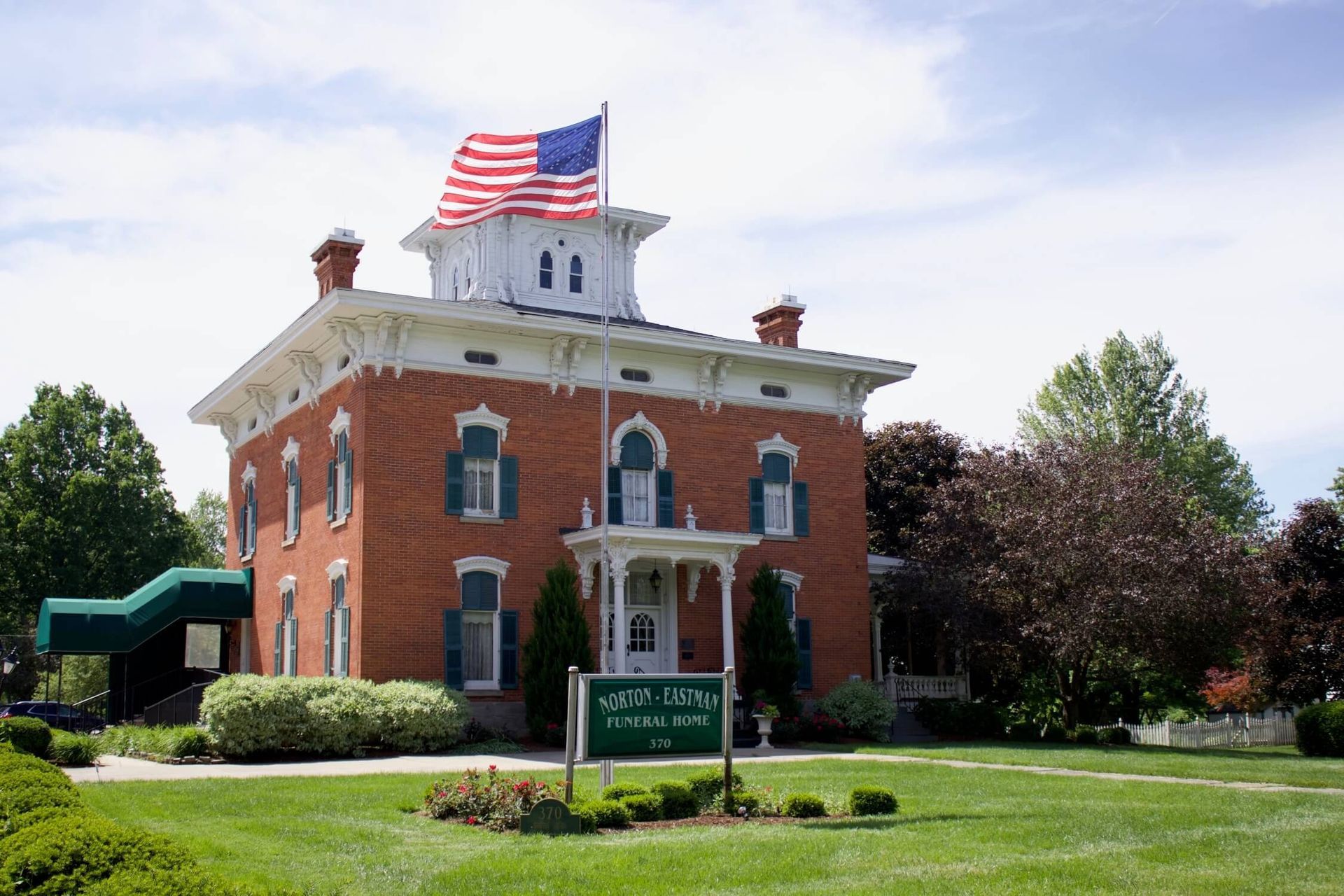 Brick building with US flag, sign reads
