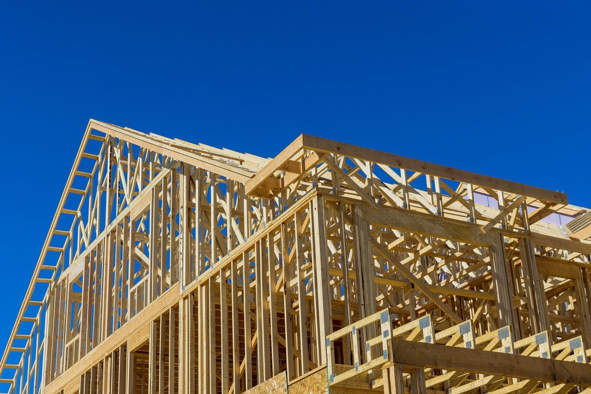 A house is being built with a blue sky in the background.