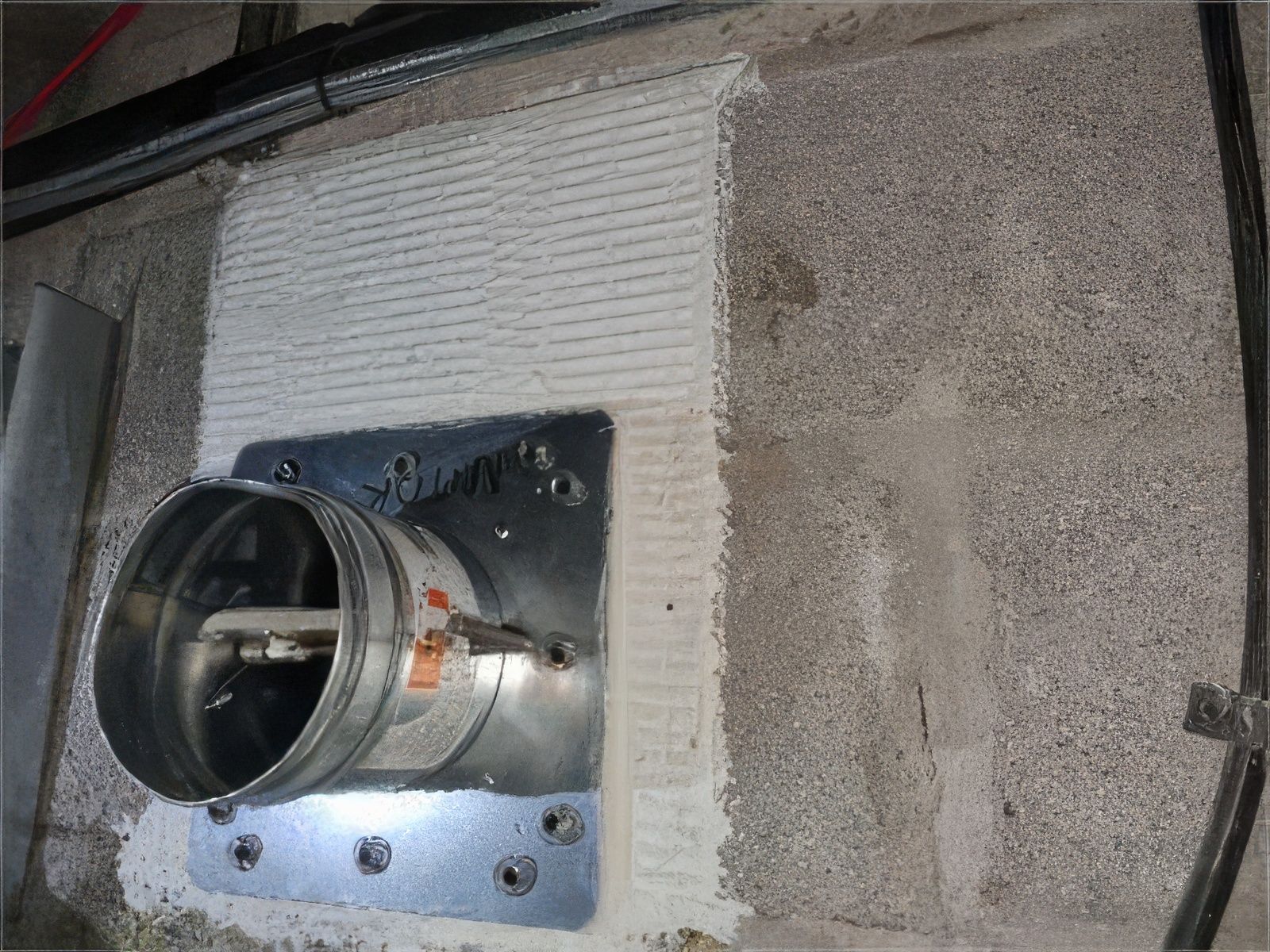 Inside view of a metal duct with a damper. The damper is made of a metal grating.