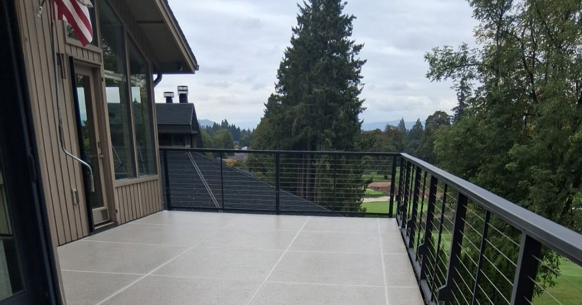 Industrial room with pipes, pump, and speckled floor.