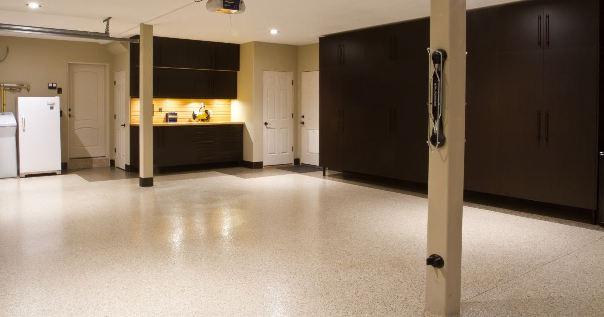 Spacious garage with brown storage cabinets, light-colored walls, and glossy floor.