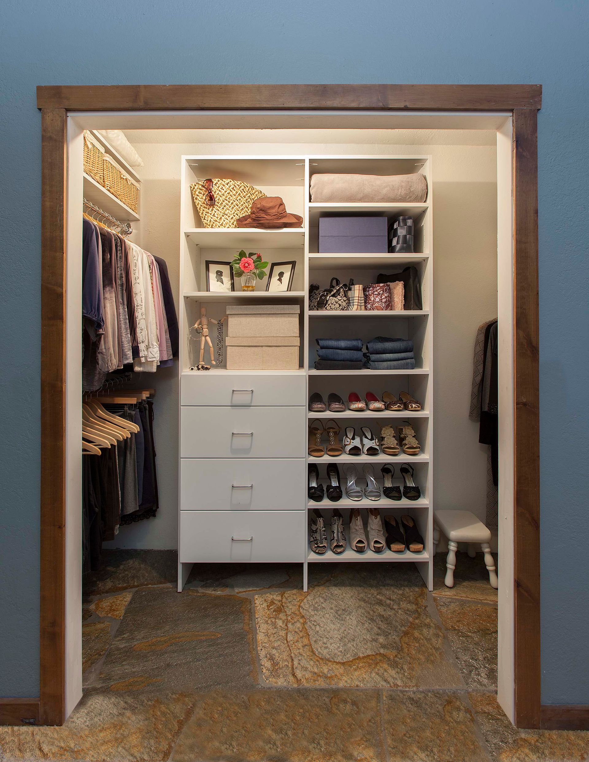 Reach In Closets with organized shelving, drawers, and hanging clothes; neutral color scheme.