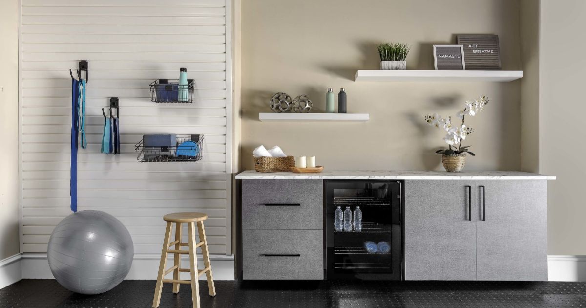 Gym space with exercise ball, stool, and storage; counter with shelves and fridge.