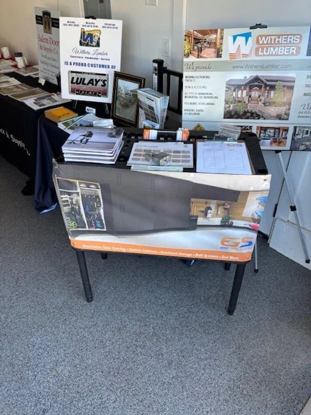 Table with lumber company information displayed at an event.