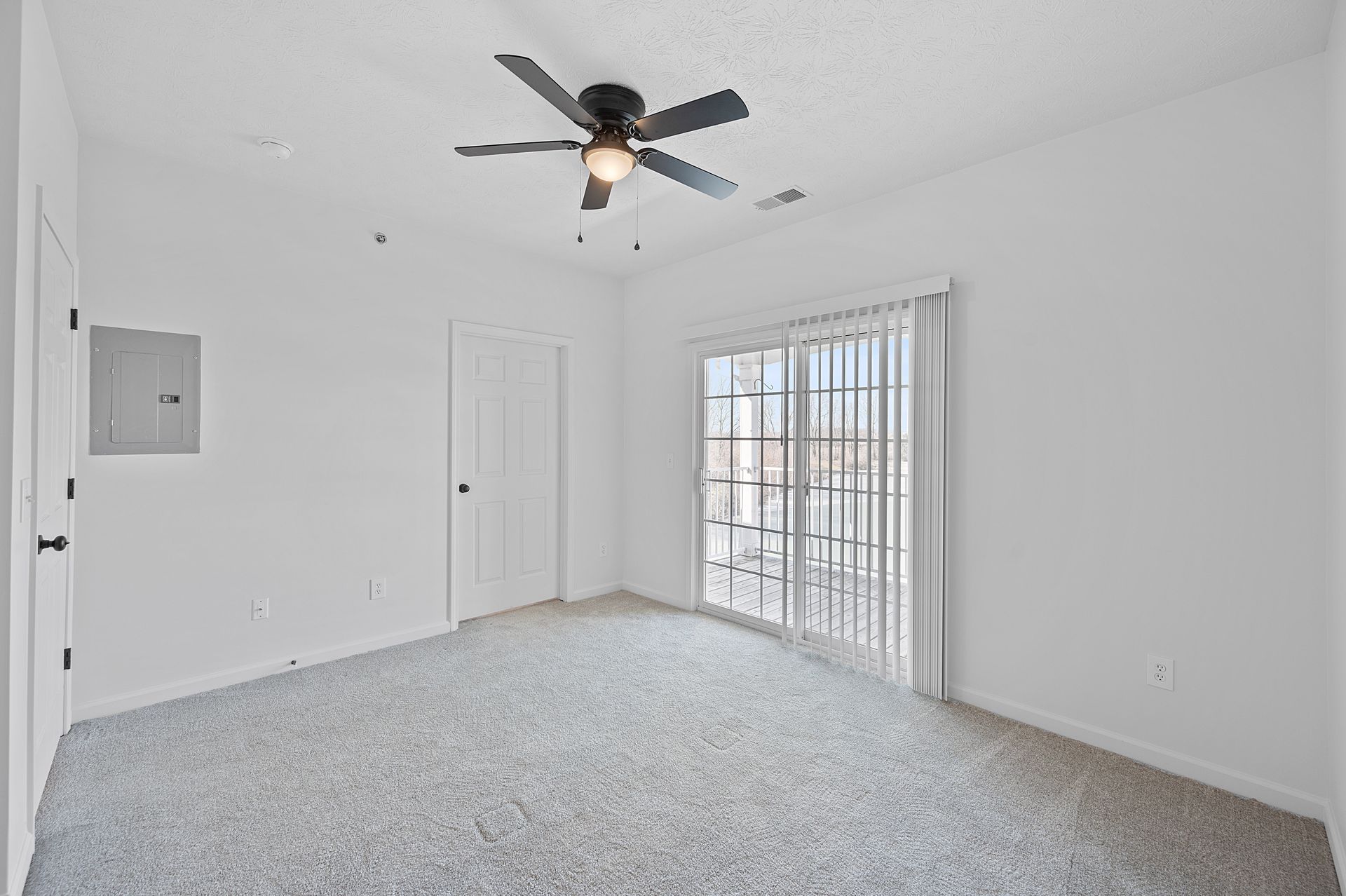 A view of the bedroom looking outside to the balcony area.