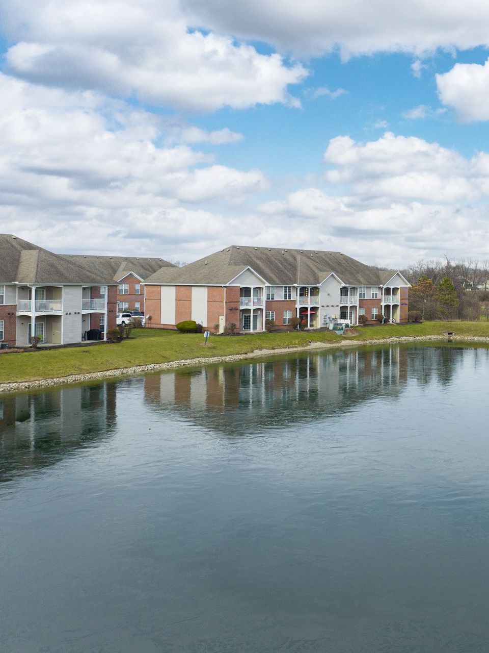 A row of apartment buildings next to a lake