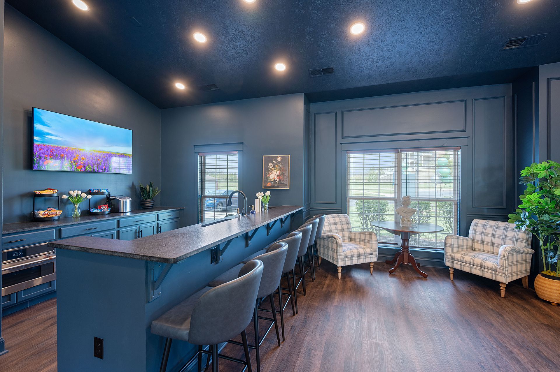 A large bar area with bar stools for gathering.