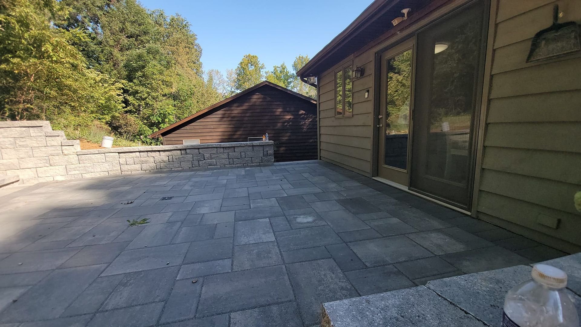 A brick walkway with a shadow of a person on it