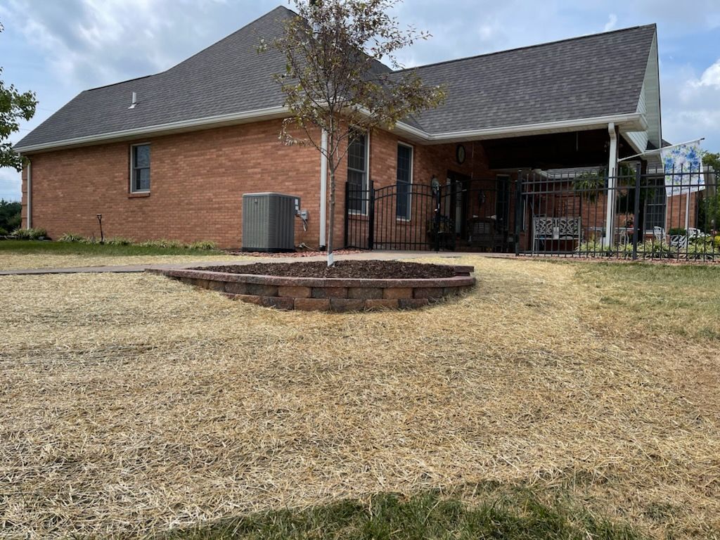 A brick house with a fire pit in front of it.
