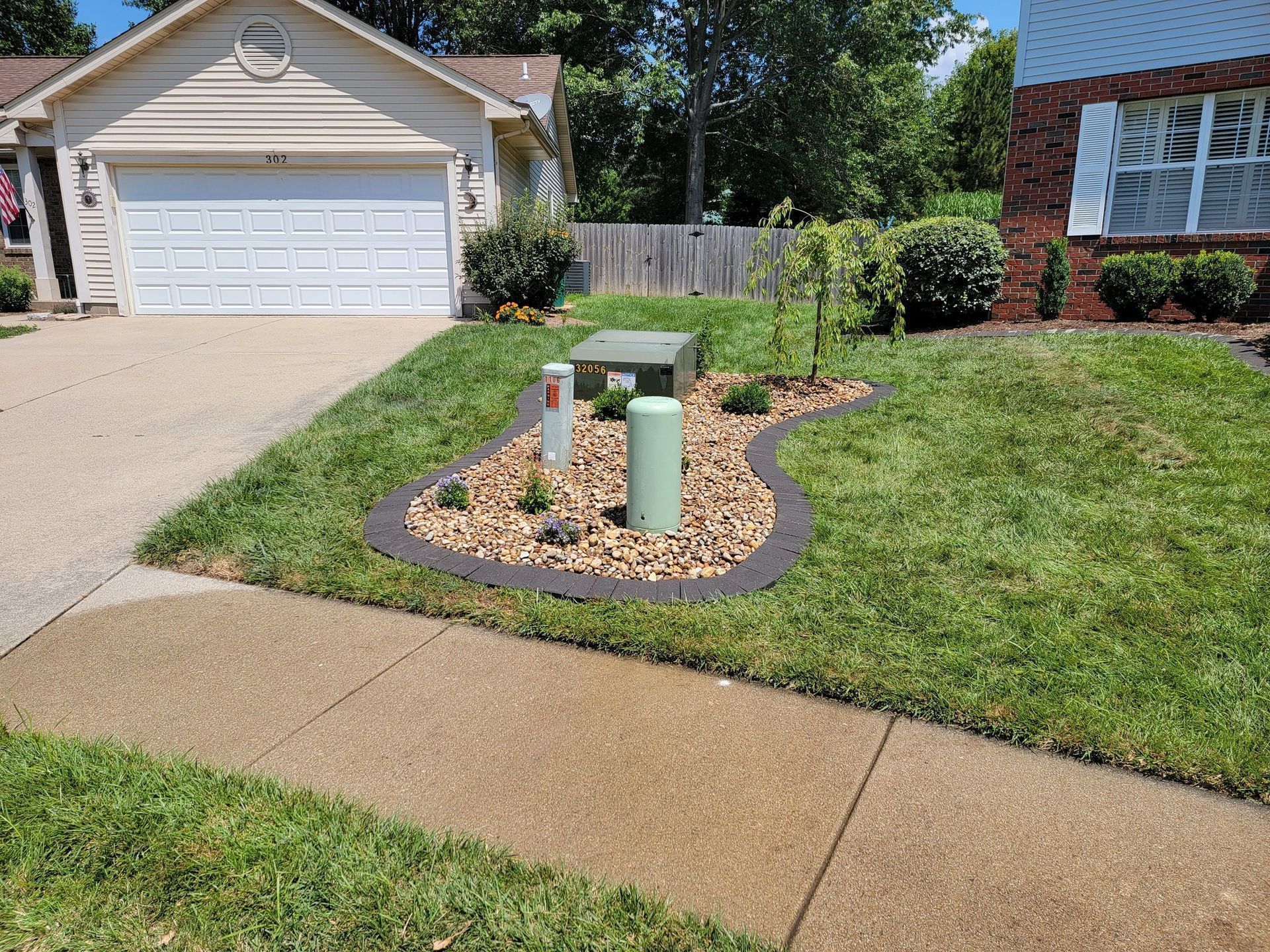 A brick house with a gravel walkway in front of it.