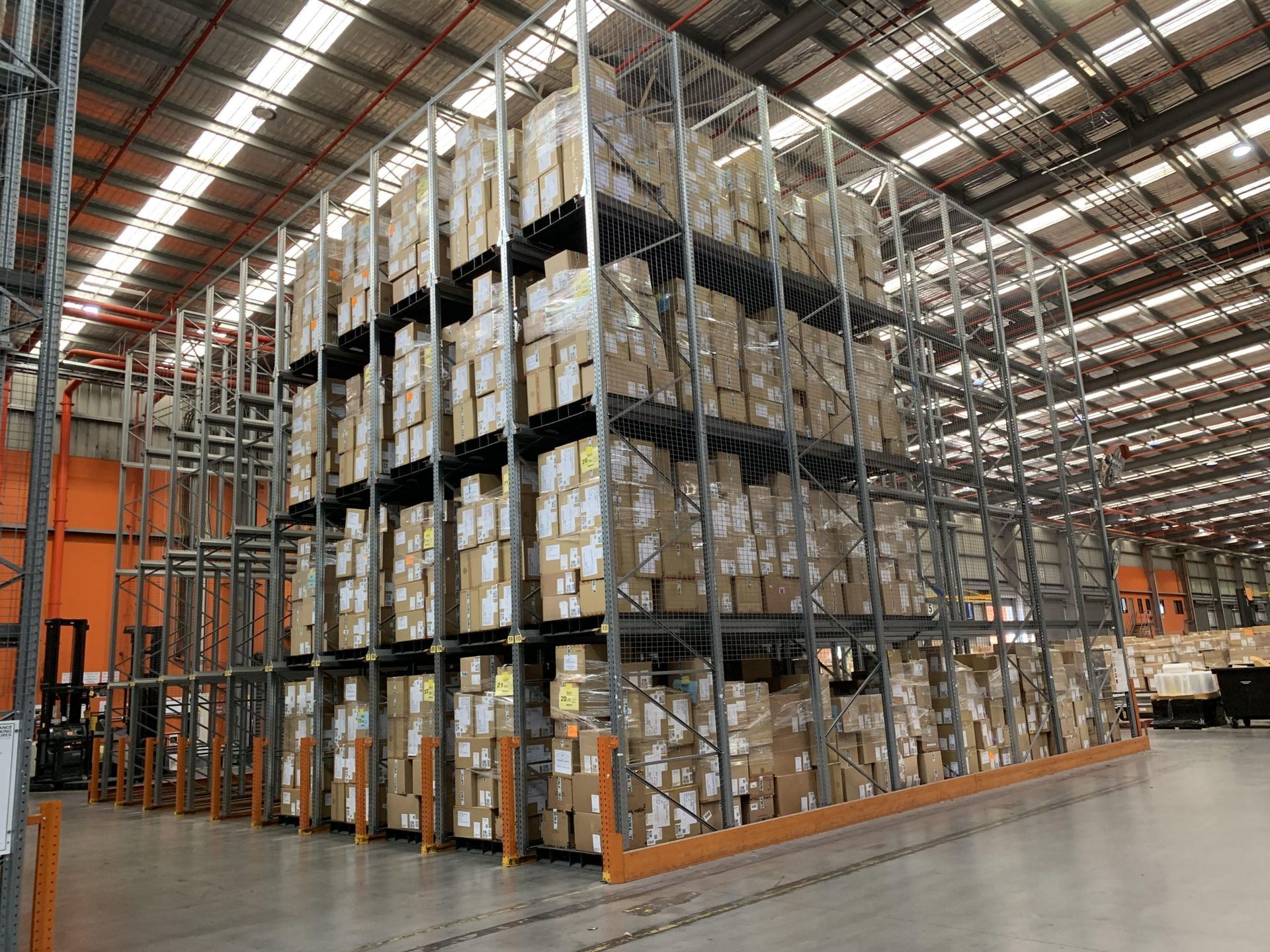 A large warehouse filled with lots of boxes on shelves.