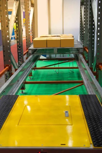 A conveyor belt with boxes on it in a warehouse.