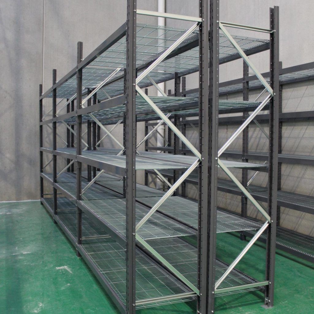 A row of metal shelves in a room with a green floor