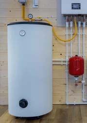 A white water heater is sitting in a room next to a boiler.
