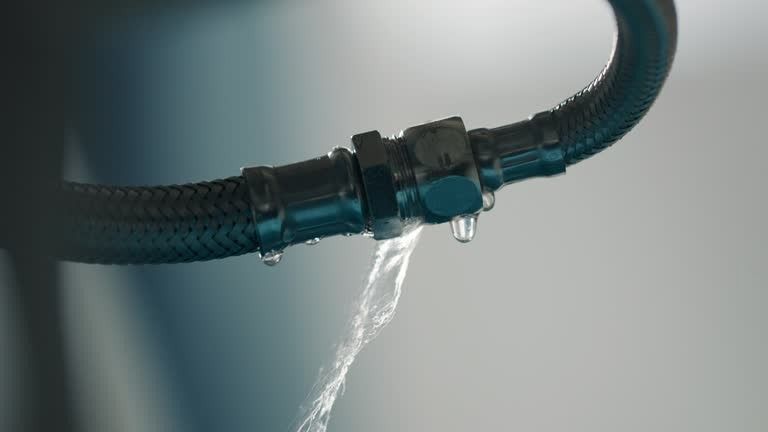 A close up of a hose with water coming out of it.