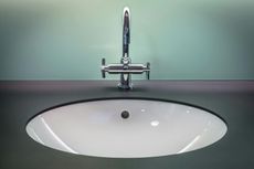 A bathroom sink with a faucet on top of it