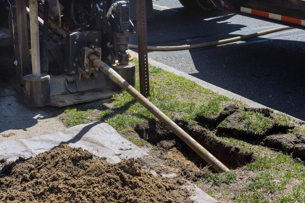 A hose is being used to dig a hole in the ground