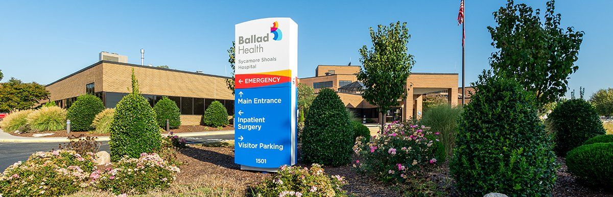 A large building with a blue sign in front of it.