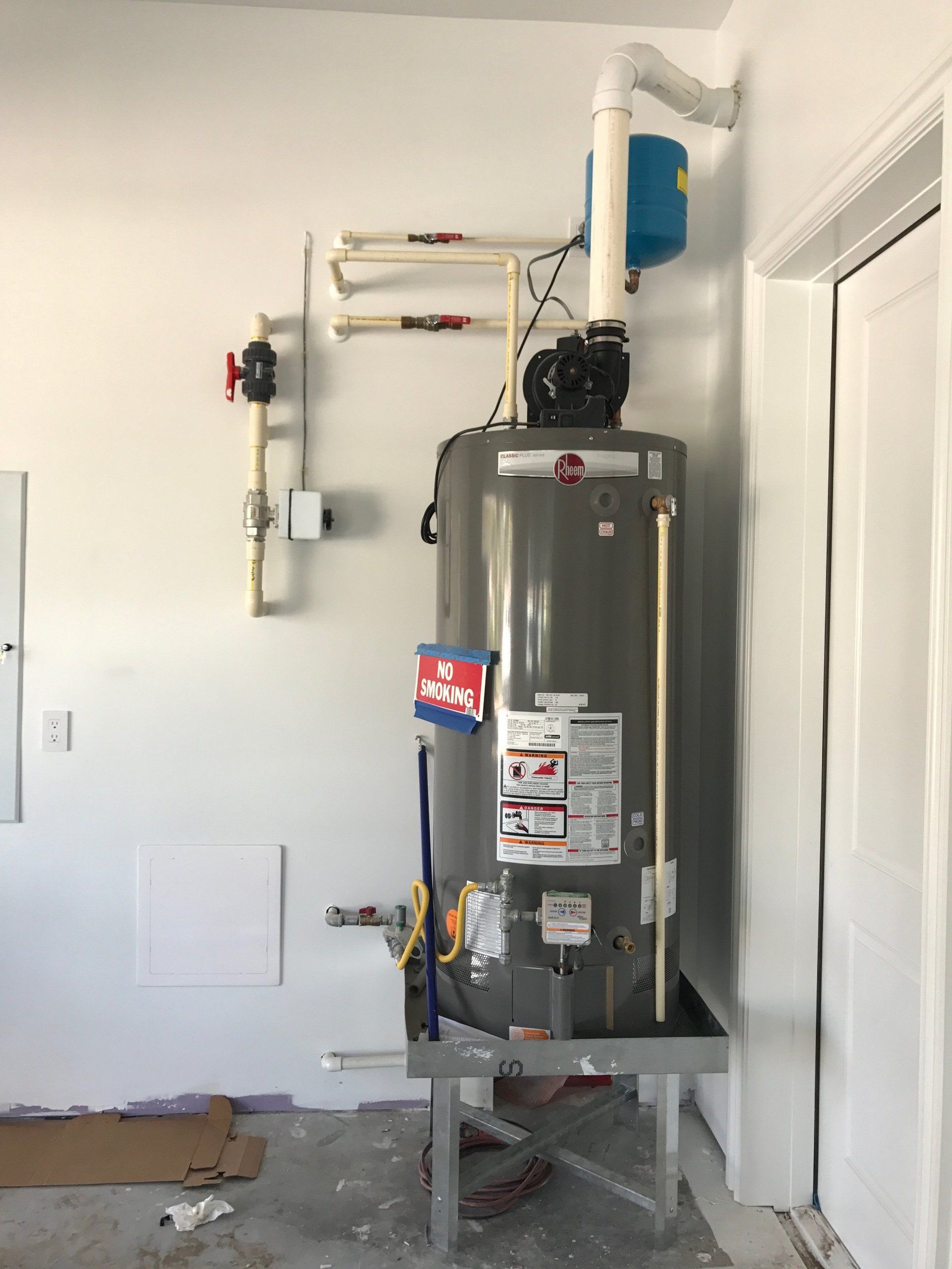 Water Heater In White Room — Naples, FL — First Class Plumbing of Florida, Inc.
