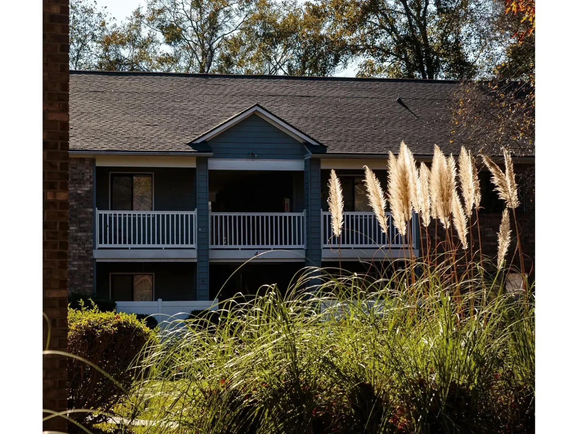 Exterior view of an apartment building with greenery in the foreground