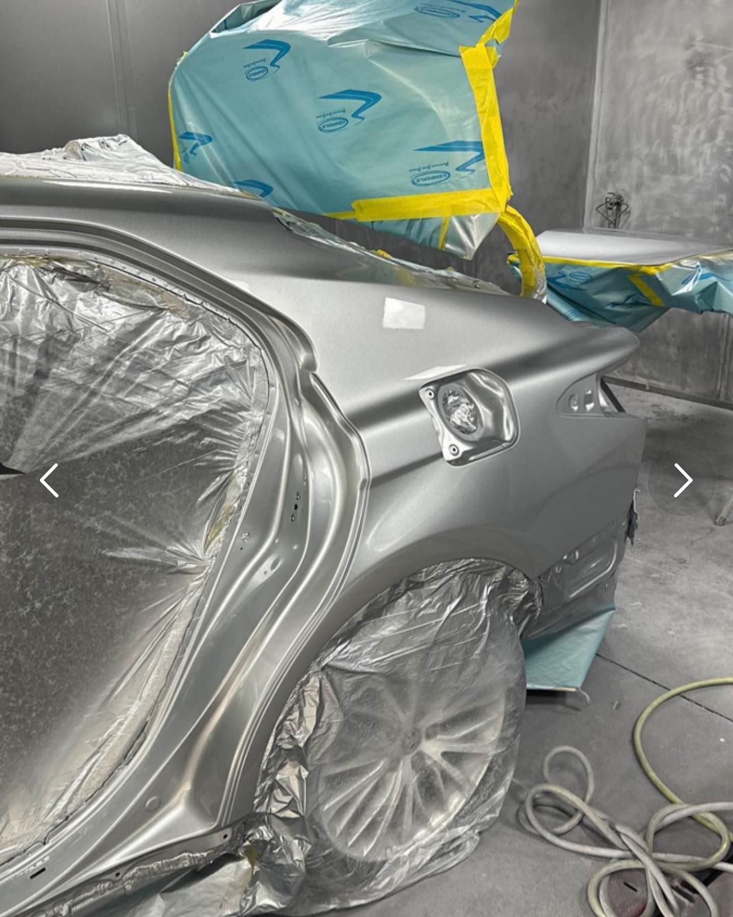 Person polishing a car hood with a buffer.