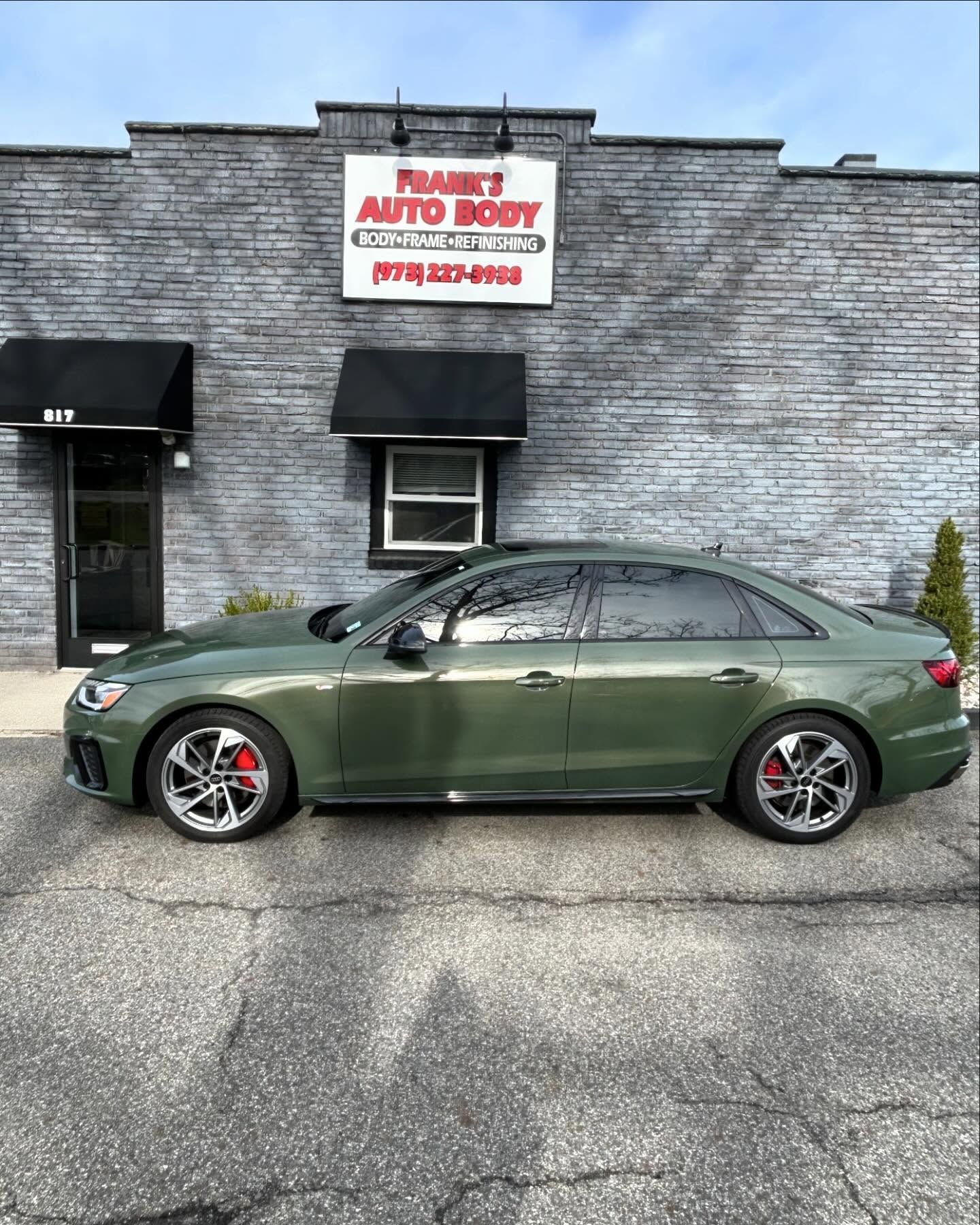 Green Audi sedan parked outside