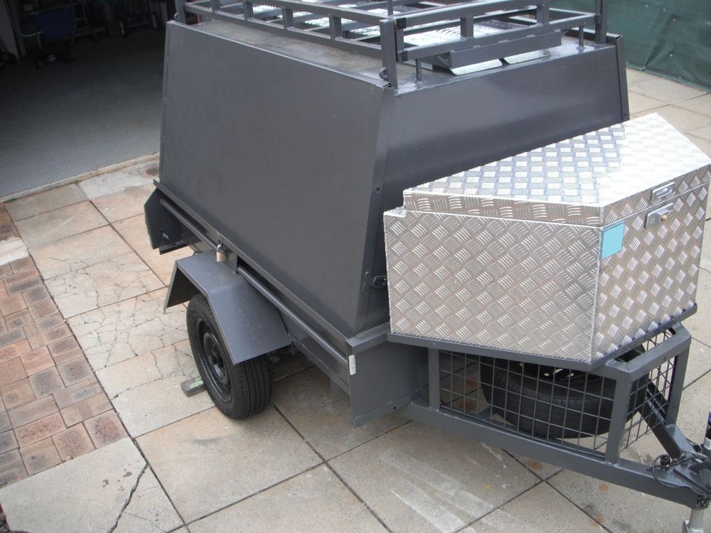 Gray utility trailer with a roof rack and silver diamond plate toolbox attached. — Caravan and Trailer Clinic Geelong in Breakwater, VIC