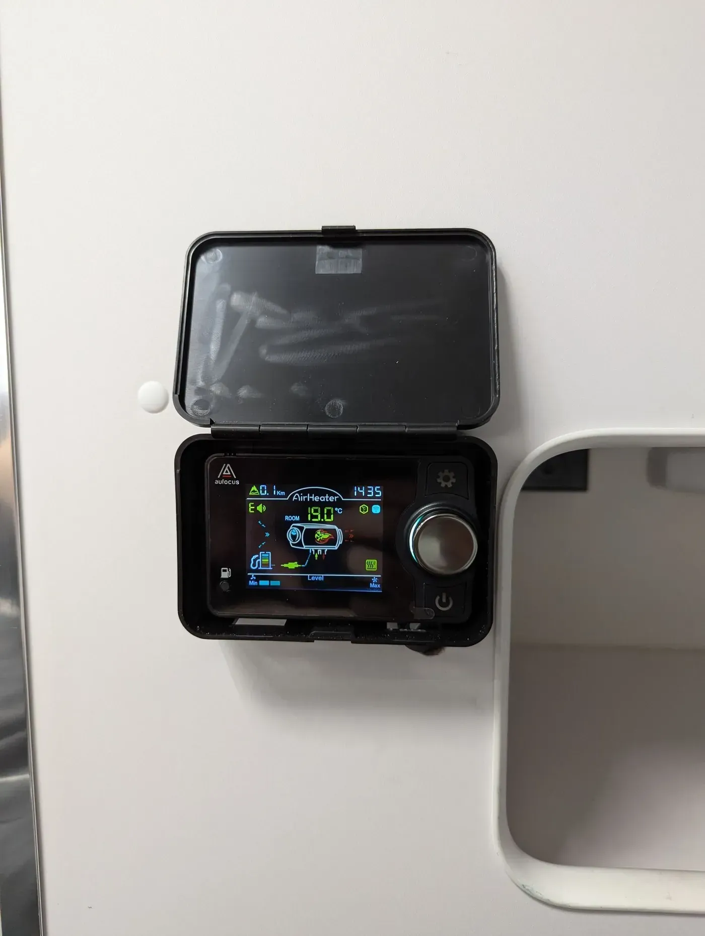 Digital control panel in a protective case, mounted on a white surface. The panel displays information on its screen. — Caravan and Trailer Clinic Geelong in Breakwater, VIC