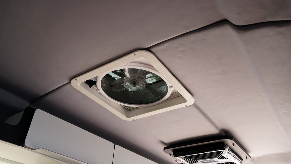 White square ceiling fan in a vehicle, with gray ceiling and a vent. — Caravan and Trailer Clinic Geelong in Breakwater, VIC
