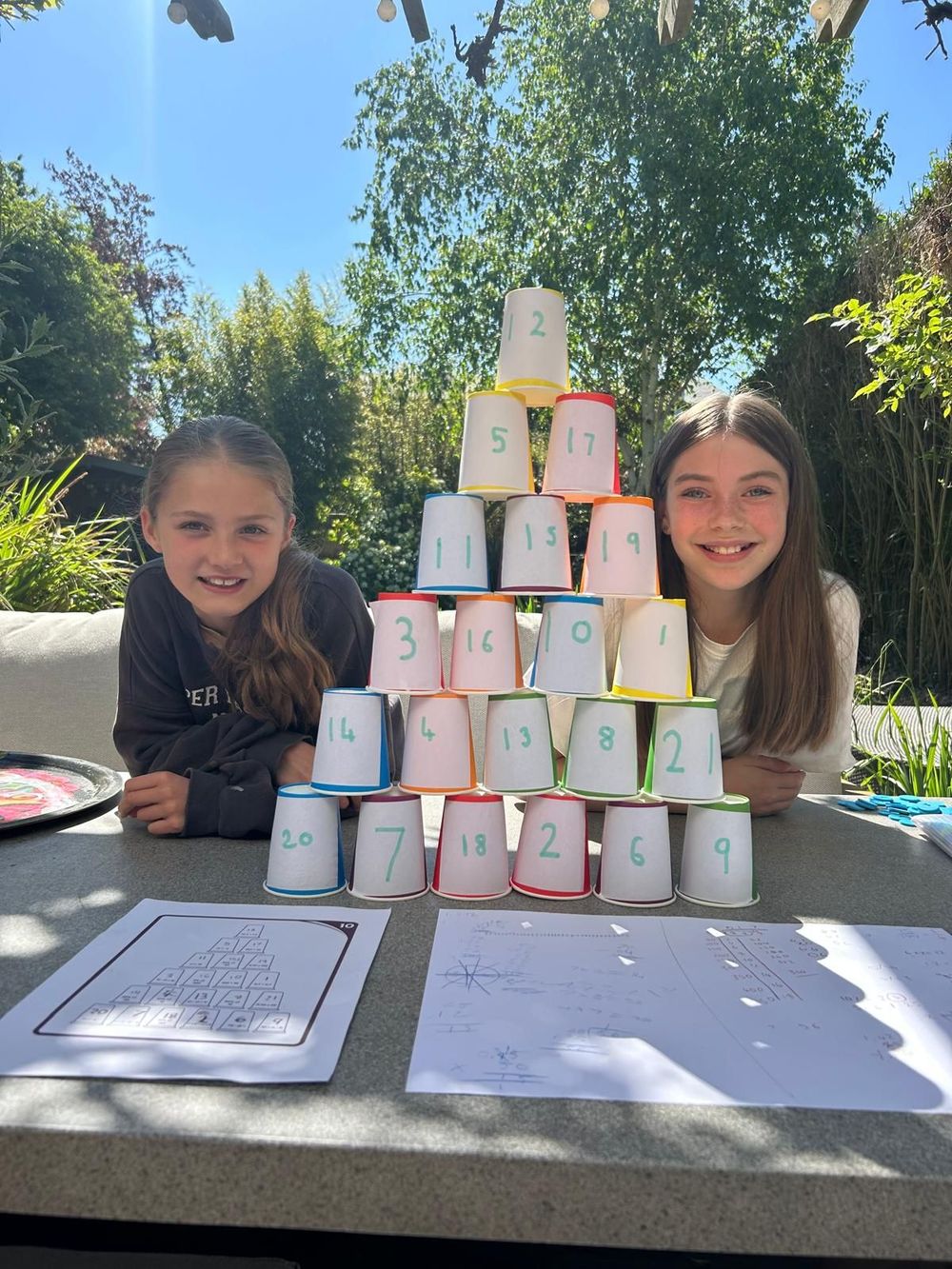 man tutoring a student pointing at laptop