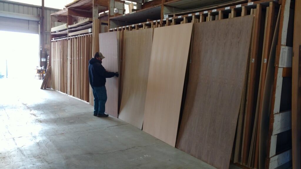 Man Arranging Hardwoods — Hardwoods & Specialty Woods in Everett, WA