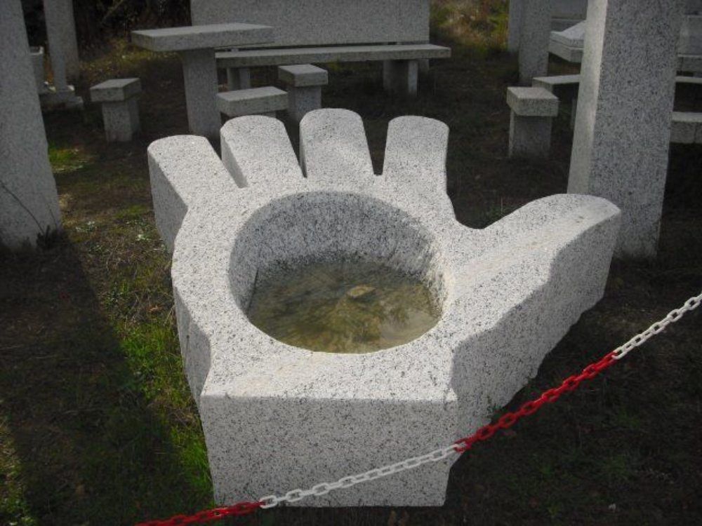 opera edile decorativa in granito a forma di mano
