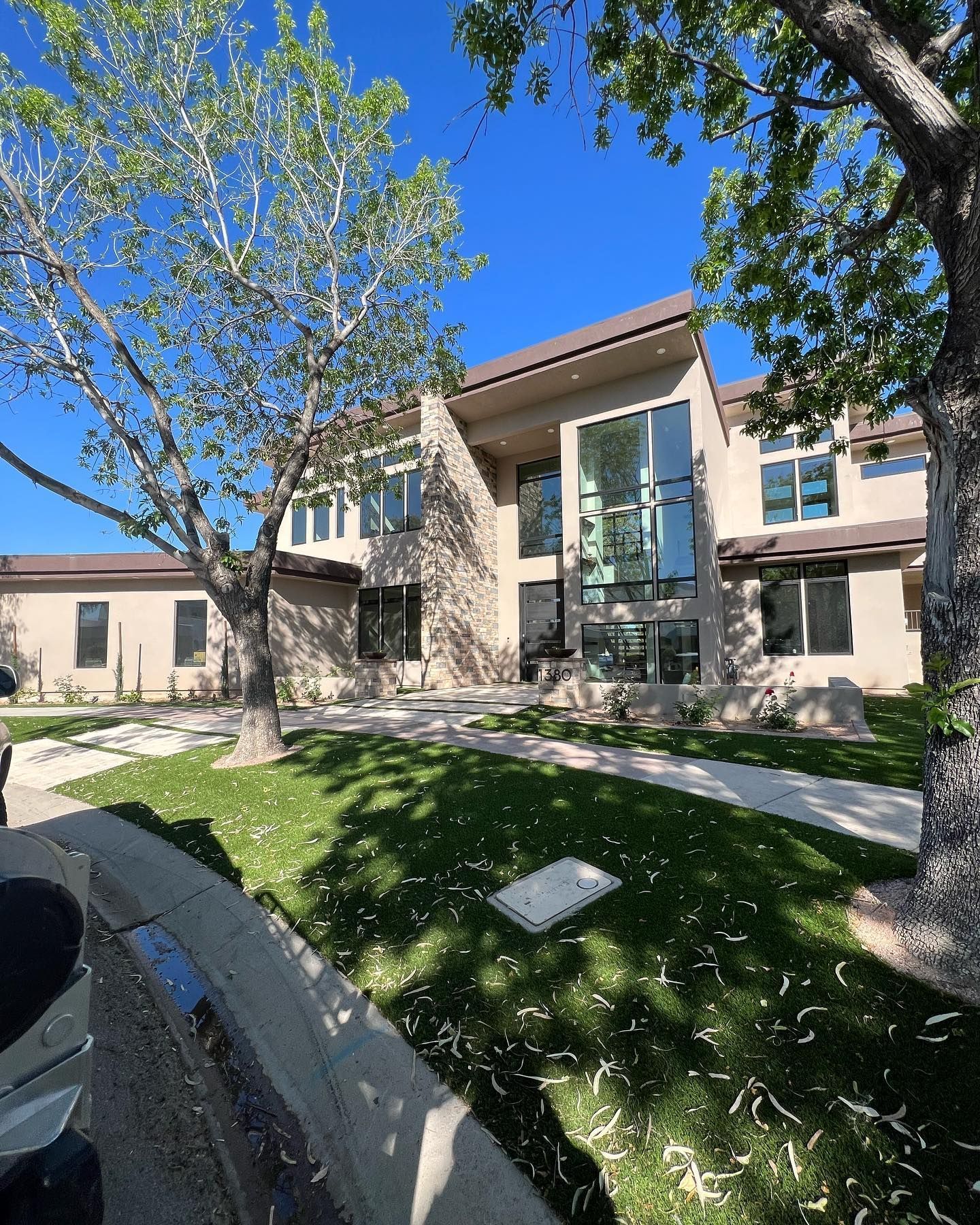 A large house with a lot of windows and trees in front of it
