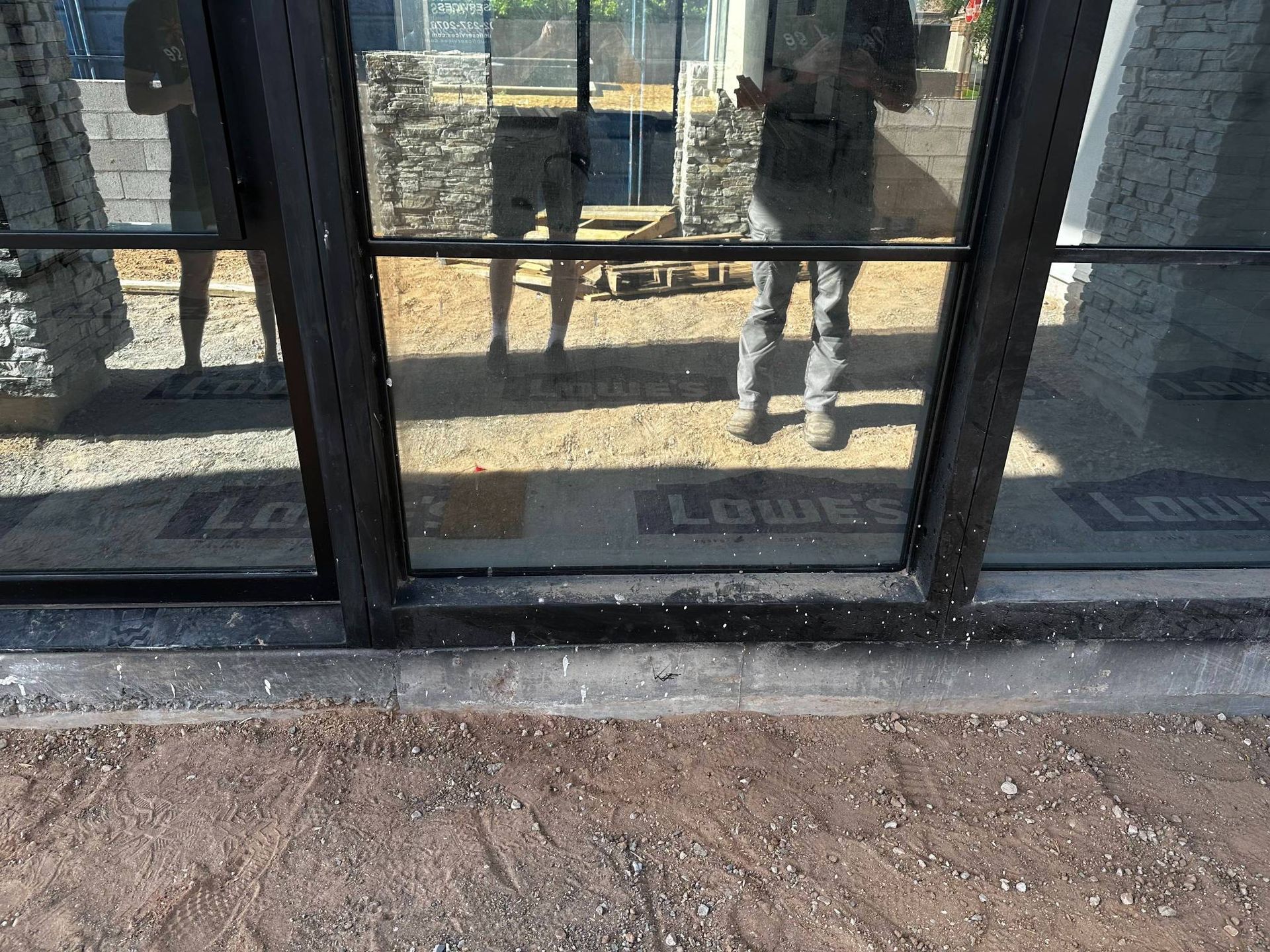 A window with blinds on it is on a brick building.