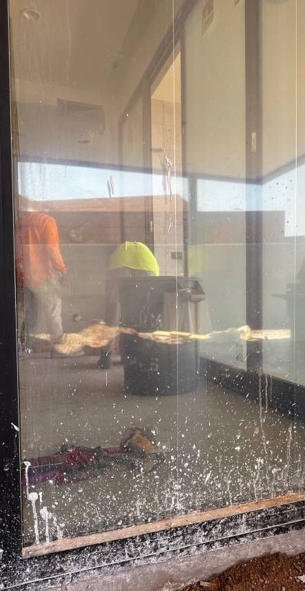 A person is taking a picture of themselves in a window.