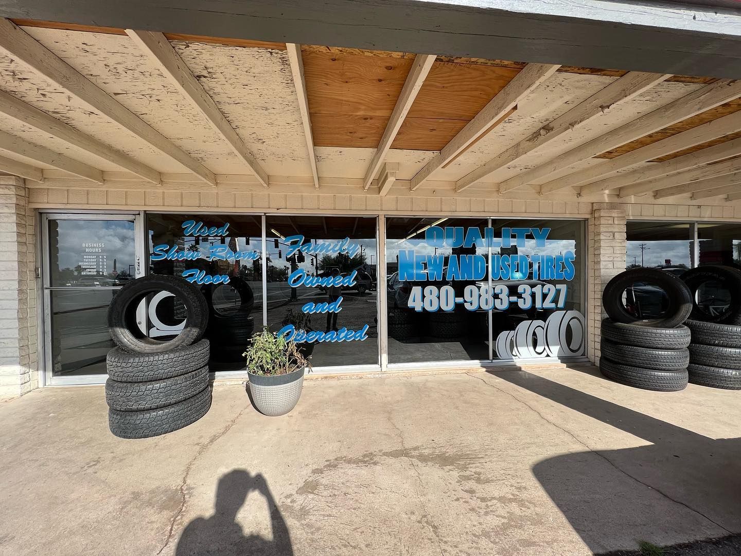 A store front with a lot of tires in front of it