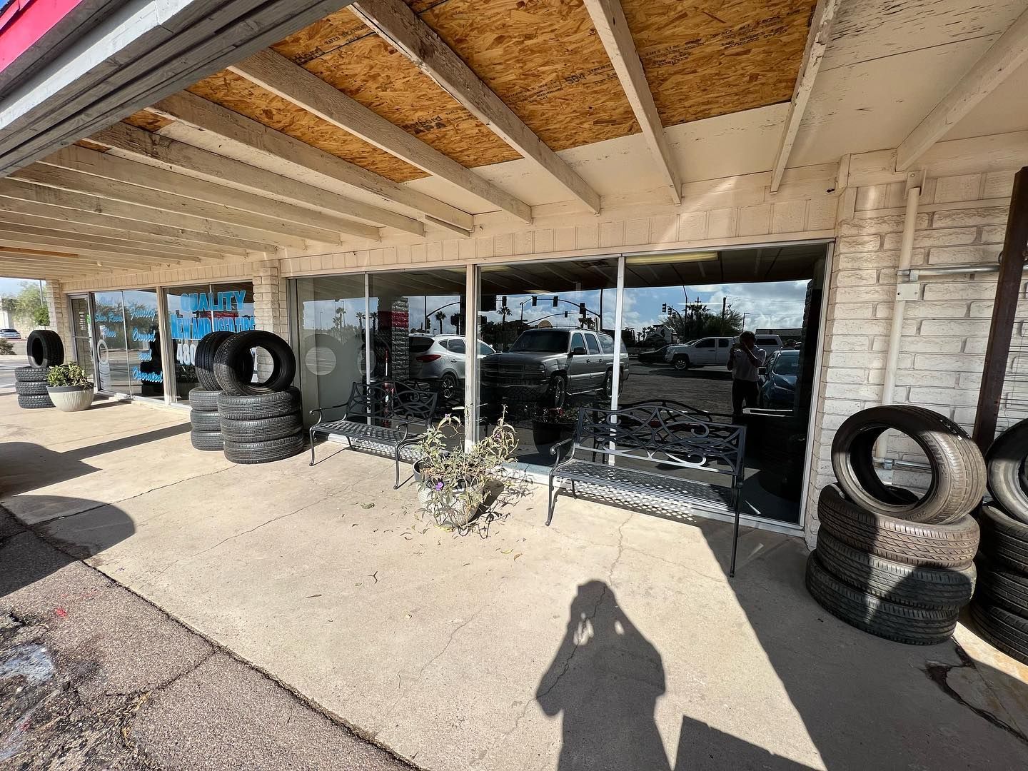 A store front with a lot of tires in front of it.