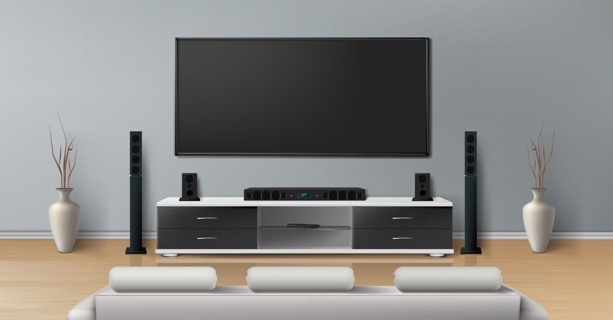 Modern home theater setup with a large wall-mounted TV, surround sound speakers, and sleek furniture — Complete Audio in Bundaberg, QLD